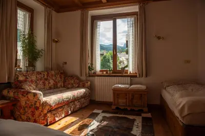 a living room with a couch and a window at Masito Apartments The Hub in Cortina dʼAmpezzo