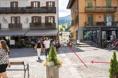 a group of people walking down a city street at Masito Apartments The Hub in Cortina dʼAmpezzo