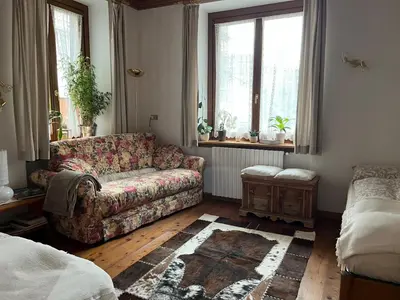 a living room with a couch and a window at Masito Apartments The Hub in Cortina dʼAmpezzo