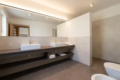 a bathroom with two sinks and a large mirror at Pramian1394 in Cermes