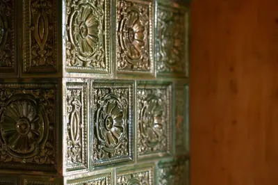 a close up of a wooden wall with golditures at Pramian1394 in Cermes