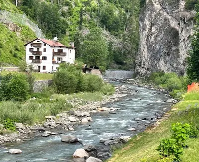 a house on the side of a river at Casa di Charme sul Civetta Dolomiti in Caprile