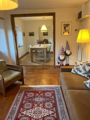 a living room with a couch and a table at Casa di Charme sul Civetta Dolomiti in Caprile