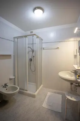 a bathroom with a shower and a toilet and a sink at Hotel Sella Ronda Serenella - A 50 mt dalle piste da sci in Campitello di Fassa