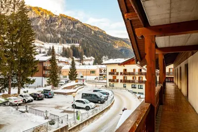 a view of a parking lot with cars parked at Hotel Sella Ronda Serenella - A 50 mt dalle piste da sci in Campitello di Fassa