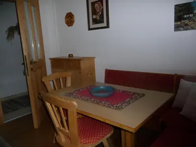a wooden table with a bowl on top of it at Haus am Park in Rasùn di Sotto