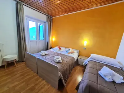 a bedroom with two beds with towels on them at Excelsior Hotel Cimone LowCost in San Martino di Castrozza
