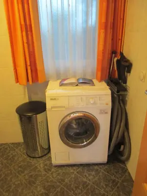 a washing machine in a room with a window at CHALET LEE's HERZNESCHTL in Rodengo
