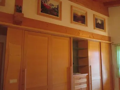 a room with a closet and some pictures on the wall at CHALET LEE's HERZNESCHTL in Rodengo