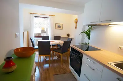 a kitchen and dining room with a table and chairs at Apartments Rezia in Ortisei