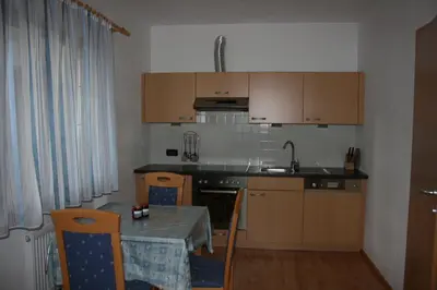 a kitchen with a table and a sink and a counter top at Lüch da Börz in Antermoia