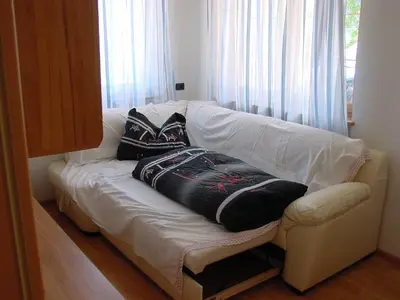 a white couch with pillows on it in a room at Lüch da Börz in Antermoia