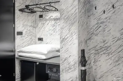 a room with a bed on a table with a mirror at ADV HOME - Exclusive Rooms in Bolzano