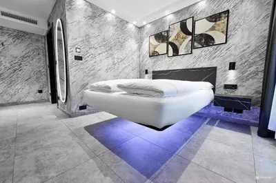a white bath tub in a room with a fireplace at ADV HOME - Exclusive Rooms in Bolzano