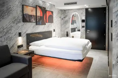a bedroom with a large white bed and a couch at ADV HOME - Exclusive Rooms in Bolzano