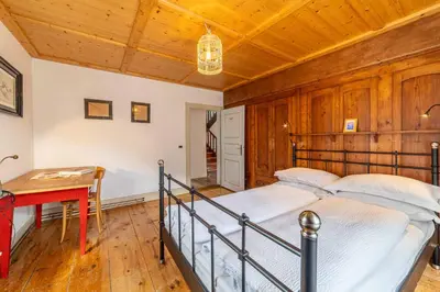 a bedroom with a bed and a wooden ceiling at La Casa dei Botiri in Rocca Pietore