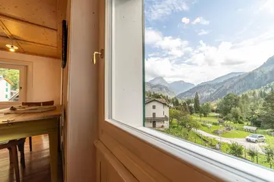 a window in a room with a view of a mountain at La Casa dei Botiri in Rocca Pietore