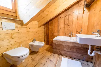 a bathroom with a toilet and a sink and a tub at La Casa dei Botiri in Rocca Pietore