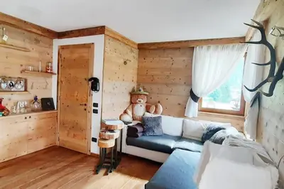 a living room with a couch and a teddy bear at 3BDRM Luxury Magic Flat near Cortina with Garage in Villanova
