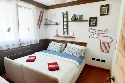 a bedroom with a large bed with red cushions at 3BDRM Luxury Magic Flat near Cortina with Garage in Villanova