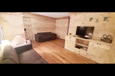 a living room with a couch and a flat screen tv at 3BDRM Luxury Magic Flat near Cortina with Garage in Villanova
