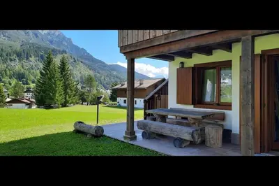 a porch of a house with a bench and a field at 3BDRM Luxury Magic Flat near Cortina with Garage in Villanova