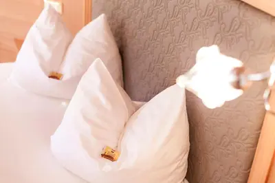 a close up of pillows on a bed at Dorfhotel Beludei in Santa Cristina in Val Gardena
