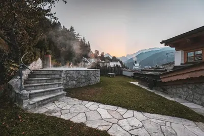 a set of stairs in a yard with a house at Dorfhotel Beludei in Santa Cristina in Val Gardena