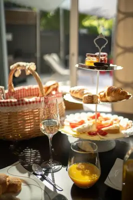 a table with plates of food and glasses of wine at Chalet Merangardenvilla in Merano