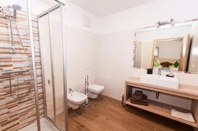 a bathroom with a toilet and a sink and a shower at B&B Incanto in Cles