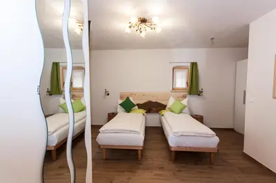 a room with two beds and a mirror at B&B Incanto in Cles