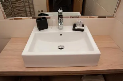 a white sink in a bathroom with a mirror at B&B Incanto in Cles