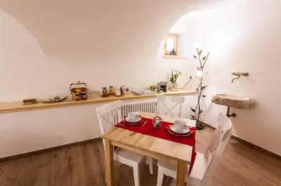 a dining room with a table and chairs at B&B Incanto in Cles