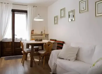 a living room with a white couch and a table at Casa Remo 3 by WelcHome in Chiapuzza