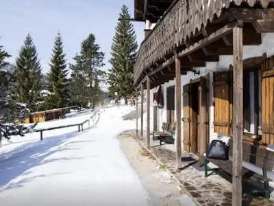 a building with snow on the ground next to a street at Casa Remo 3 by WelcHome in Chiapuzza