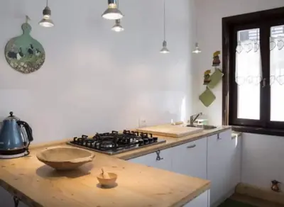 a kitchen with a stove and a wooden counter top at Casa Remo 3 by WelcHome in Chiapuzza