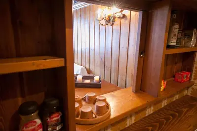 a small room with a shelf with candles in it at Verocai Studio by WelcHome in Cortina dʼAmpezzo
