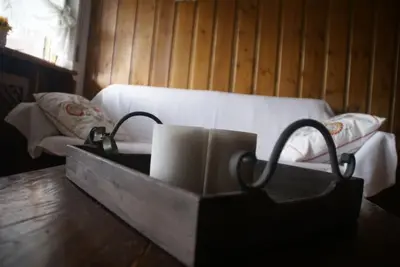 a tray with two rolls of paper towels and a bed at Verocai Studio by WelcHome in Cortina dʼAmpezzo