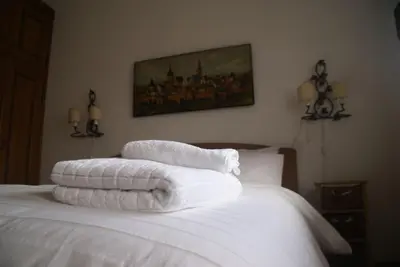 a bed with white towels on top of it at Verocai Studio by WelcHome in Cortina dʼAmpezzo