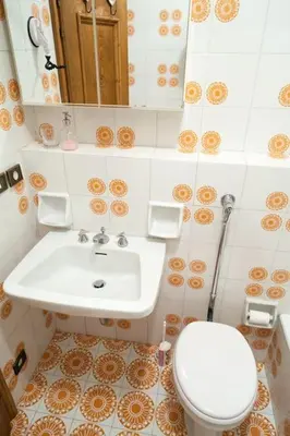 a bathroom with a sink and a toilet at Verocai Studio by WelcHome in Cortina dʼAmpezzo