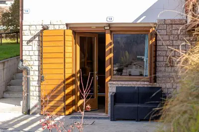 a tiny house with a dog sitting in the doorway at Villa Maria in Falcade