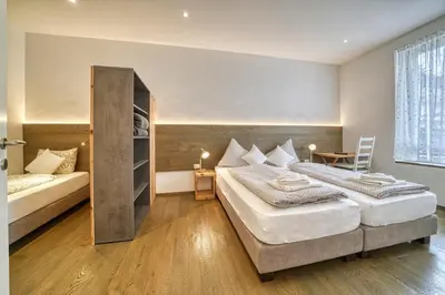 a hotel room with two beds and a table at Apartment Heinz in Merano