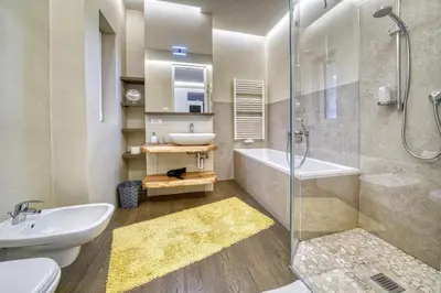 a bathroom with a shower and a sink and a tub at Apartment Heinz in Merano