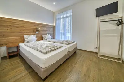 a bedroom with two beds and a flat screen tv at Apartment Heinz in Merano