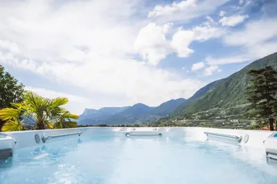 a swimming pool with mountains in the background at Apartment Egghof im Weingut in Merano