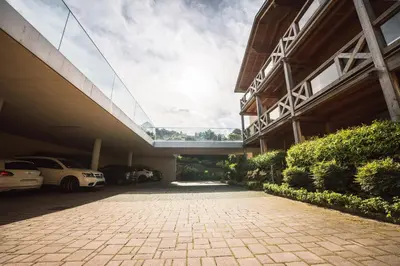 a large building with cars parked in a parking lot at Apartment Egghof im Weingut in Merano