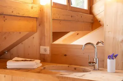 a bathroom with a sink and a mirror at Cà Bianca delle Dolomiti in Cortina dʼAmpezzo