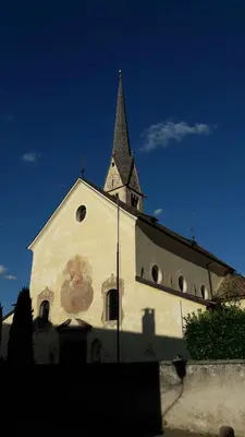 a church with a steeple on top of a building at mama's room in Egna