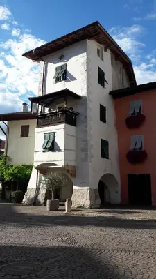 a white building with a balcony on the side of it at mama's room in Egna