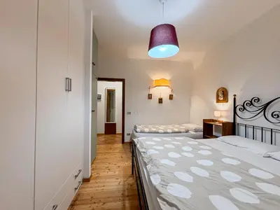 a bedroom with two beds and a purple light at Appartamento Al Ruscello in Canazei